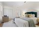 Bright bedroom featuring light walls, wood floor, closet, and a comfortable chair at 7042 Twin Hills Ter, Lakewood Ranch, FL 34202