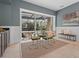 Bright dining area with pool views, stylish furnishings and neutral decor with sliding glass door at 7042 Twin Hills Ter, Lakewood Ranch, FL 34202