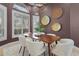 Spacious dining room with a modern table and rich wall color at 7042 Twin Hills Ter, Lakewood Ranch, FL 34202
