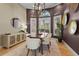 Dining room with modern chandelier, large windows, and stylish decor at 7042 Twin Hills Ter, Lakewood Ranch, FL 34202