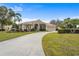 Single-Gathering home with circular driveway, landscaping, and palm trees at 7042 Twin Hills Ter, Lakewood Ranch, FL 34202