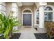 Inviting front entrance with a double door, decorative columns, and well-maintained landscaping at 7042 Twin Hills Ter, Lakewood Ranch, FL 34202