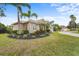 Beautiful home with lush front yard landscaping, a tile roof, and an attached two car garage at 7042 Twin Hills Ter, Lakewood Ranch, FL 34202