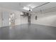 Spacious garage with painted floor, AC unit and access to kitchen at 7042 Twin Hills Ter, Lakewood Ranch, FL 34202