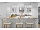 Large kitchen island featuring white cabinetry, counter seating, and modern design at 7042 Twin Hills Ter, Lakewood Ranch, FL 34202
