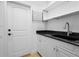 Laundry room with white cabinets, granite countertop, and sink at 7042 Twin Hills Ter, Lakewood Ranch, FL 34202