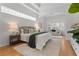 Bright and airy main bedroom with sitting area and hardwood floors at 7042 Twin Hills Ter, Lakewood Ranch, FL 34202
