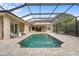 An inviting screened-in pool with a brick paver deck and comfortable outdoor seating creates a relaxing backyard retreat at 7042 Twin Hills Ter, Lakewood Ranch, FL 34202