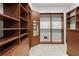 Spacious walk-in closet with custom shelving, ample storage, and a built-in safe at 7042 Twin Hills Ter, Lakewood Ranch, FL 34202