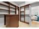 Organized walk-in closet with built-in shelving, drawers, and a view to the main bedroom at 7042 Twin Hills Ter, Lakewood Ranch, FL 34202