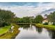 Waterfront property with lush greenery and calm waters at 7117 Victoria Circle, University Park, FL 34201