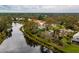House nestled on a waterfront lot with mature trees at 7117 Victoria Circle, University Park, FL 34201