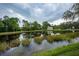 Serene backyard view overlooking a tranquil lake at 7117 Victoria Circle, University Park, FL 34201