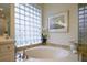 Bathroom with a large soaking tub and glass block window at 7117 Victoria Circle, University Park, FL 34201