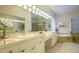 Elegant bathroom with double sinks, soaking tub, and walk-in shower at 7117 Victoria Circle, University Park, FL 34201