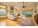 Bright living room with hardwood floors, fireplace, and access to pool at 7117 Victoria Circle, University Park, FL 34201