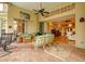 Spacious covered patio with comfortable seating and views into the home at 7117 Victoria Circle, University Park, FL 34201