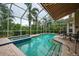 Enclosed pool and spa area with patio furniture and retractable awning at 7117 Victoria Circle, University Park, FL 34201