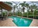 Enclosed pool and spa area with patio furniture and retractable awning at 7117 Victoria Circle, University Park, FL 34201