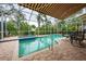 Enclosed pool and spa area with patio furniture and retractable awning at 7117 Victoria Circle, University Park, FL 34201