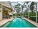 Enclosed pool and spa with patio furniture, awning, and home access at 7117 Victoria Circle, University Park, FL 34201