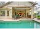 Inviting pool area with patio, covered lanai, and outdoor kitchen at 7117 Victoria Circle, University Park, FL 34201