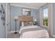 Bedroom with light blue walls and a comfortable bed at 8061 Moonbeam Ave, Sarasota, FL 34241