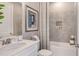 Bathroom with a shower/tub combo, white vanity, and gray tile at 8065 Moonbeam Ave, Sarasota, FL 34241