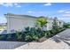 Well-maintained landscaping surrounds a modern home with elegant brick paver walkway at 8105 Moonbeam Ave, Sarasota, FL 34241