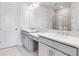 Spacious bathroom featuring a dual sink vanity with quartz countertops, and large mirror at 8113 Moonbeam Ave, Sarasota, FL 34241