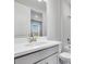 Modern bathroom with a white vanity, brushed-nickel faucet, and a shower/tub combo with white tile at 8113 Moonbeam Ave, Sarasota, FL 34241