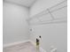 Practical closet space featuring tile flooring, wire shelving, and visible utility hookups for convenience at 8113 Moonbeam Ave, Sarasota, FL 34241