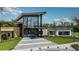 Modern clubhouse exterior with large windows and tropical landscaping at 8113 Moonbeam Ave, Sarasota, FL 34241