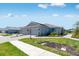 Beautiful single-story home with well-maintained landscaping, paver driveway and neutral-colored exterior at 8113 Moonbeam Ave, Sarasota, FL 34241