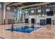 Spacious community gymnasium with basketball court, volleyball net, and high ceilings at 8113 Moonbeam Ave, Sarasota, FL 34241