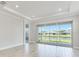 Living room with an open floor plan and views of the lake from the sliding glass doors to the patio at 8113 Moonbeam Ave, Sarasota, FL 34241