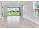 Open living room features views of the lake from screened in lanai and lots of natural light at 8113 Moonbeam Ave, Sarasota, FL 34241