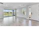 Light and airy living room with water views from the screened in lanai and large windows at 8113 Moonbeam Ave, Sarasota, FL 34241