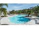 Resort-style pool with lounge chairs and a shaded seating area at 8113 Moonbeam Ave, Sarasota, FL 34241