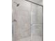 Walk-in shower with gray wall tile and a frameless glass door at 8113 Moonbeam Ave, Sarasota, FL 34241