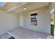 Front porch with light gray walls, a white door, and a window overlooking the yard at 1006 Hagle Park Rd, Bradenton, FL 34212