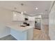 Modern kitchen with white cabinets, quartz countertops, and stainless steel appliances at 1006 Hagle Park Rd, Bradenton, FL 34212