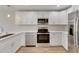 Modern kitchen with white cabinets, stainless steel appliances and quartz countertops at 1006 Hagle Park Rd, Bradenton, FL 34212