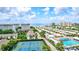Aerial view of coastal community with tennis courts, pool, and ocean views at 1200 E Peppertree Ln # 607, Sarasota, FL 34242