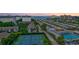 Aerial view of community with tennis courts, pool, and ocean views at 1200 E Peppertree Ln # 607, Sarasota, FL 34242