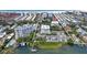 Aerial view of waterfront property, showing building, pool, tennis courts, and beach access at 1200 E Peppertree Ln # 607, Sarasota, FL 34242