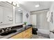 Clean bathroom with black vanity, bathtub, and shower at 1200 E Peppertree Ln # 607, Sarasota, FL 34242