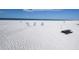Beachfront view with picnic table and lounge chairs at 1200 E Peppertree Ln # 607, Sarasota, FL 34242