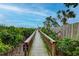 Wooden boardwalk path with lush landscaping leading to a pier at 1200 E Peppertree Ln # 607, Sarasota, FL 34242