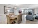 Elegant dining area with a large mirror and access to the balcony at 1200 E Peppertree Ln # 607, Sarasota, FL 34242
